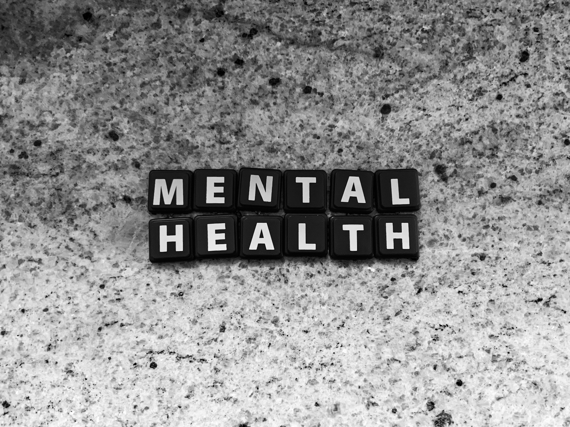 Tiles on counter spelling out MENTAL HEALTH